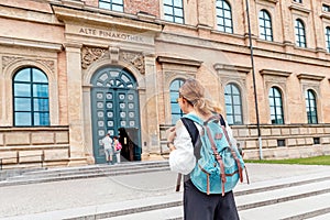 girl with backpack at the old Pinakothek art gallery in Munich, Germany photo