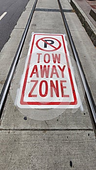 Tow Away Zone, no parking sign on street