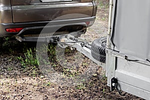 Tow hitch on a car. Trailer drawbar with spare wheel