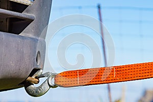 Tow hook with orange strap on car. Towing equipment