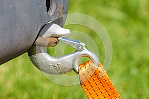 Tow hook with orange strap on car. Towing equipment