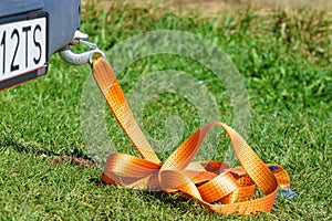 Tow hook with orange strap on car. Towing equipment