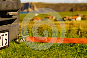 Tow hook with orange strap on car. Towing equipment