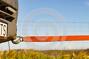 Tow hook with orange strap on car. Towing equipment