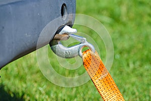 Tow hook with orange strap on car. Towing equipment