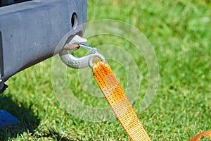 Tow hook with orange strap on car. Towing equipment