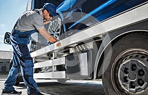 Tow Man Making Sure the Car is Secured for Transport