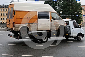 Tow truck carrying a small van