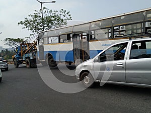 Tow truck delivers the damaged BMTC Bus, Repair and recovery vehicle towing a broken city bus