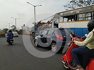 Tow truck delivers the damaged BMTC Bus, Repair and recovery vehicle towing a broken city bus