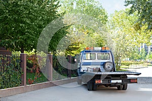 Tow truck parked outdoors on sunny day