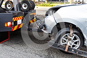 Tow truck towing broken down car from accident