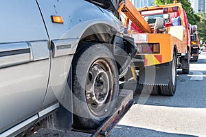 Tow truck towing a broken down car in emergency