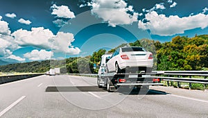 Tow Truck Transporting Car Or Help On Road Transports Wrecker Broken Car. Car Service Transportation Concept. Auto