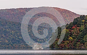 Towada lake and sight seeing boat cruising during autumn season.