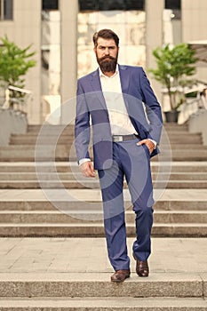 Toward business achievements. Conquer business world. Office worker confidently step on stairs. Bearded man going to