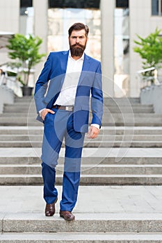 Toward business achievements. Conquer business world. Office worker confidently step on stairs. Bearded man going to