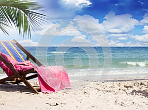 Towel on beach chairs at beautiful tropical beach