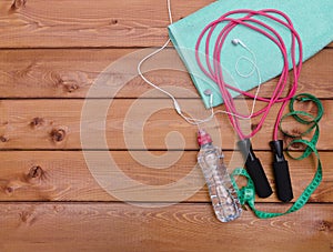 Towel, bottle of water measure tape headphones and skipping rop