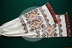 The towel is embroidered light-brown and dark brown threads.