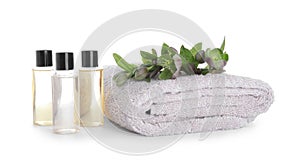 Towel, essential oils and flowers isolated. Spa treatment
