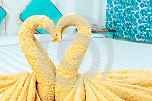 Towel folded in swan heart shape