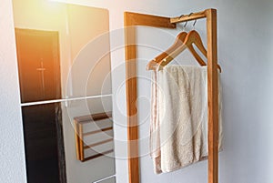Towel hang in the shower room - towel in wood clothes hanger