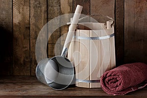 Towel, a ladle and a bucket for a bath