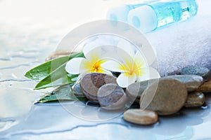 towel and oil tube. Flowers and stones spa