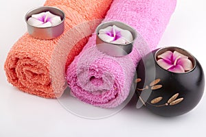 Towel rolls with flower candles and woodcraft