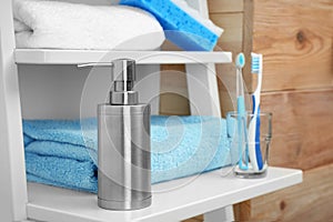 Towel and soap dispenser on shelf