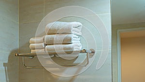 Towel on the stainless shelf in bathroom.Concept clean folded textile for spa and hygiene modern interior hotel room