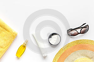 Towel, sun lotion, glasses on white background top view space for text photo