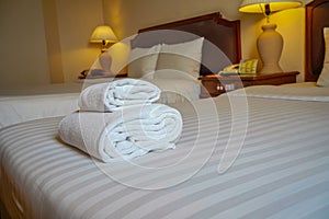 Towels and bedding on double beds in dormitories or guesthouse rooms that are empty