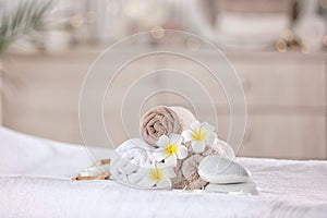 Towels and candles on massage table in modern spa salon. Place for relaxation