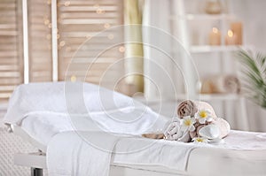 Towels and candles on massage table in spa salon. Place for relaxation