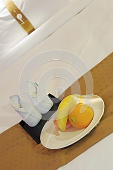 Towels and fruit on bed