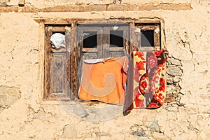 Towels hanging to dry on a weathered wooden window