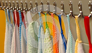 Towels hung on metal hooks in the bathroom of a preschool