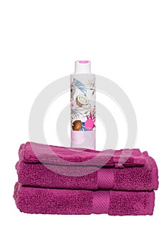 Towels isolated. Closeup of a stack or pile of violet soft terry bath towels with a wash softener isolated on a white background