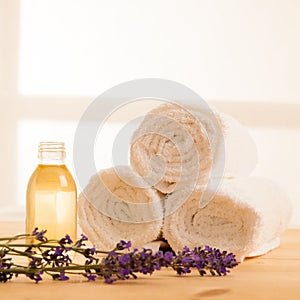 Towels lavender and masage oil on a table in spa salon photo