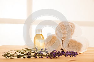 Towels lavender and masage oil on a table in spa salon