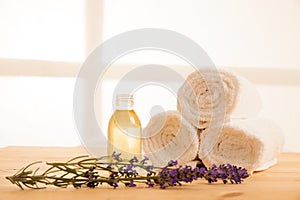 Towels lavender and masage oil on a table in spa salon photo