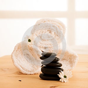 Towels and masage rocks on table in spa salon