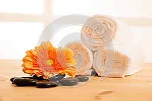 Towels and masage rocks on table in spa salon