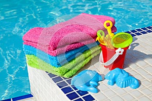 Towels and plastic toys near the swim pool