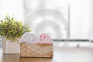 Towels on wooden table with copy space on blurred bathroom background