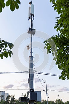 Tower 5G in the city on the road. Vertical. Moscow, Russia, 07-25-2021