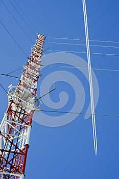 Tower, airplane and contrail photo