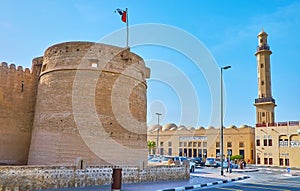 The tower of Al Fahidi Fort and minaret of Grand Mosque, Dubai, UAE